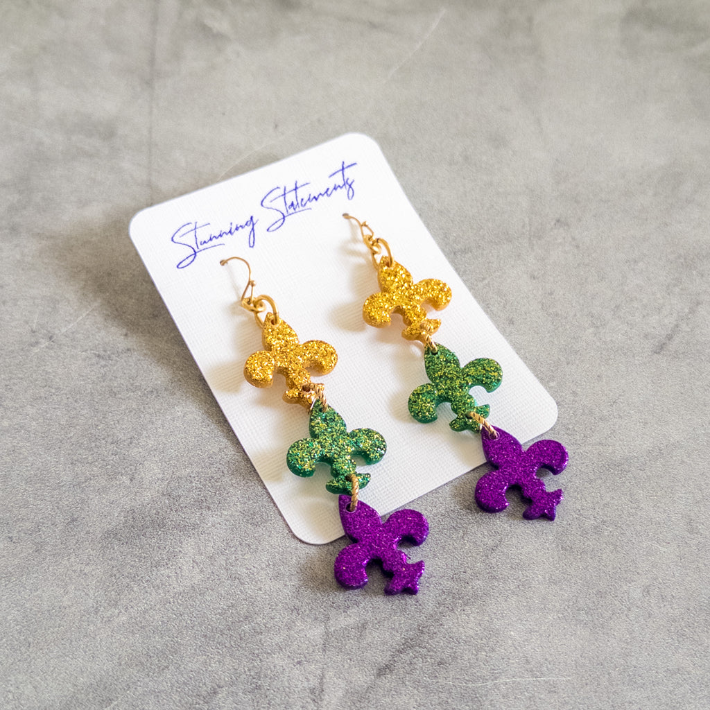stunning statements clay mardi gras dangle lightweight large big statement glitter shiny purple green gold fleur de lis earrings