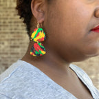 black history month juneteenth black red green yellow abstract large statement dangle lightweight multicolored festive earrings on a model